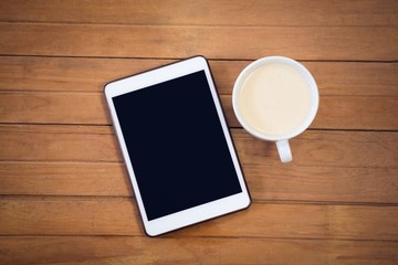 Directly above shot of digital tablet with coffee cup