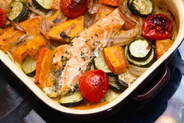 Homemade roasted salmon and vegetables in a baking tray