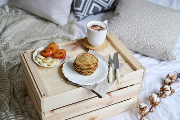 Breakfast in Bed Cappuccino Fruits Homemade Banana Pancakes Honey Sauce Wooden Table Cushion Interior Toned Copy Space White Sheets Eco Style Cotton
