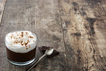 Chocolate mousse on wooden table. Copyspace.

