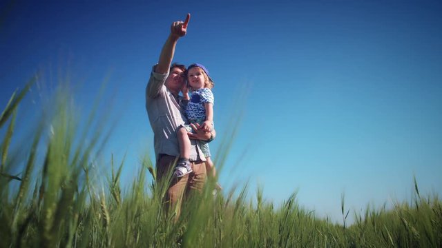 4k Dad Showing to Child the Sun in Wheat Fields