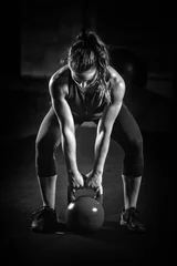 Fotobehang Woman athlete exercising with kettlebell © Microgen
