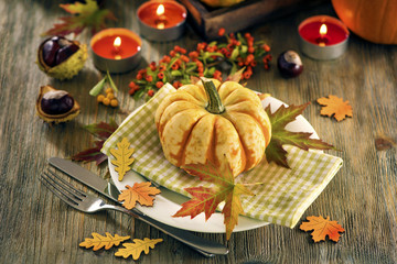 Autumn table setting with pumpkings and candles, fall home decoration for festive dinner