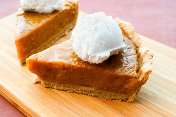 Homemade vegan pumpkin pie with coconut cream. Selective focus.