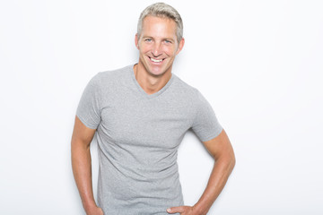 Portrait of confident mature man standing on white background