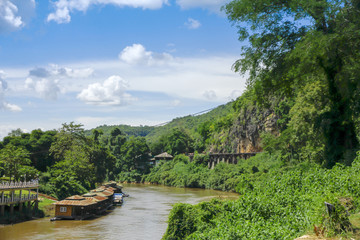 Stock Photo - By the river side. View of a holiday resort gardens