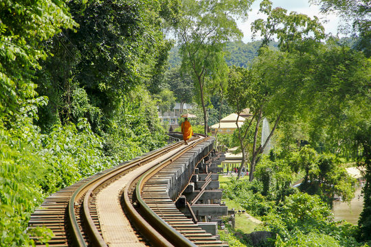 Stock Photo - Monk walks on the rails in nature