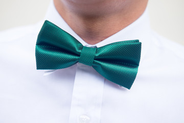 Groomsman in white shirt with green bow tie