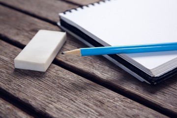 Close-up of pencil and eraser on open diary