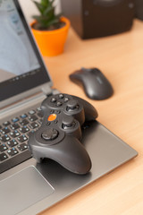 A close-up of the gamepad lying on the laptop.