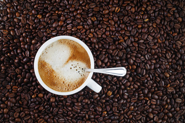 Coffee cup and coffee beans. Top view.