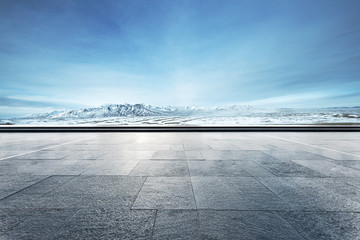 empty floor with beautiful snow mountains in blue sky - Powered by Adobe