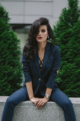 stylish fashionable sexy brunette in blue suit in the city. Fashion photo