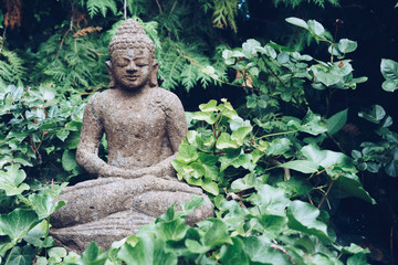 Buddha sculpture on green nature