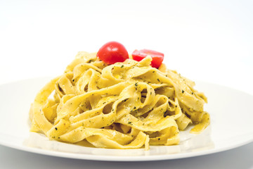 Pasta with pesto sauce and nuts on a the table