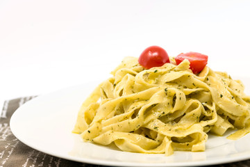 Pasta with pesto sauce and nuts on a the table