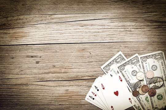 ace poker and cash on wooden background