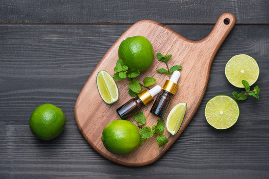Natural cosmetics for home spa. Bottle of essence oil with fresh limes