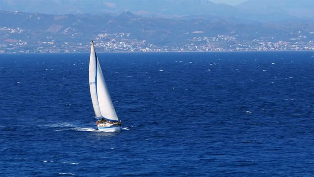 Yacht sailing on the Mediterranean sea, off the coast of Crete.