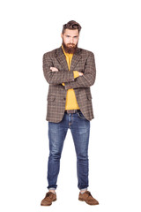 Handsome young man with beard full height standing against white background.