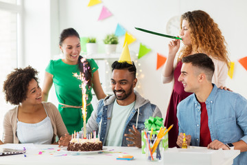 team greeting colleague at office birthday party