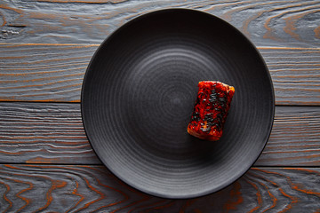 Grilled smoked eel on black plate