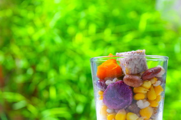Close up of mix cereals and natural fresh green background