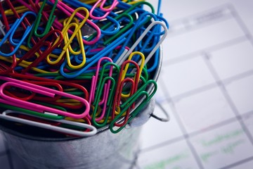 Colorful paper clips in bucket