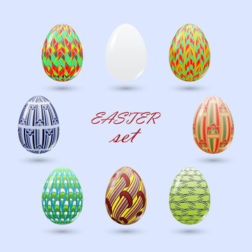 Set of Easter eggs painted in a zenart style and an unpainted white realistic egg.