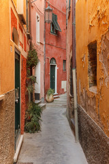 Fototapeta na wymiar Path between old colored houses in Tellaro, a small fishing village in Italy.