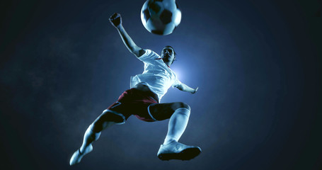 Soccer player kicks the ball on the soccer stadium. He wear unbranded sports clothes. Stadium and crowd made in 3D. © haizon