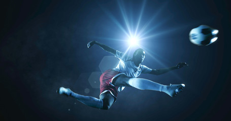 Soccer player kicks the ball on the soccer stadium. He wear unbranded sports clothes. Stadium and crowd made in 3D.