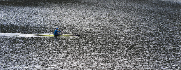 Kayak with a rower on the water. © Elena