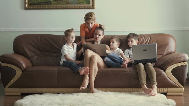 Mother with sons spends leisure time at home