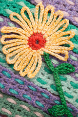 Fototapeta na wymiar Handmade wool knitted flower colorful texture background