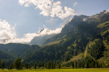 Italian mountains Alps landscape in partly cloudy summer day outdoor.