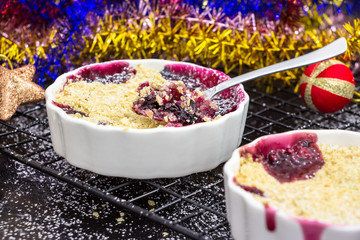 Two Homemade delicious crumble with berries in portioned individual ramekins.  Christmas concept....