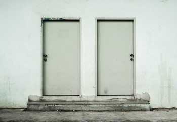 Two white door with warehouse closeup