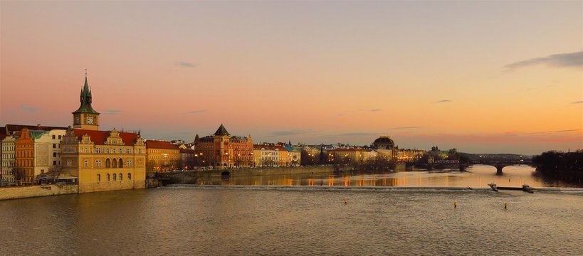 Prague sunset view from Charles Bridge over Vltava River

