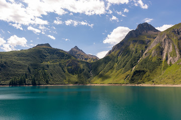 Naklejka na ściany i meble Italian mountains Alps lake landscape in partly cloudy summer day outdoor.
