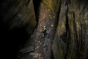 Young adult active man exploring scenic gorge in Uriezzo Italy in sunny summer day outdoor.