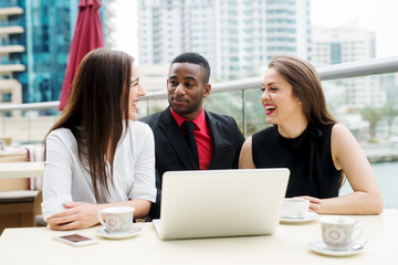 Elegant smiling colleagues are having a great time for a break.