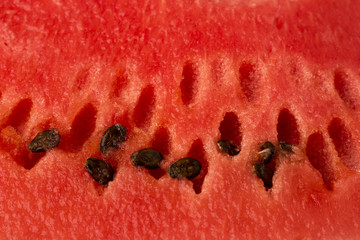 The texture of ripe, red watermelon with seeds. Close-up. Background