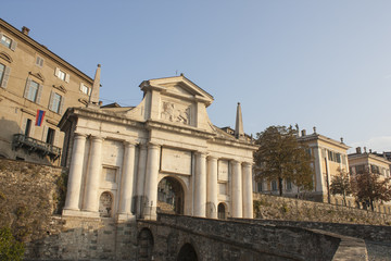 Fototapeta premium Bergamo - Old city (Citta Alta). One of the beautiful city in Italy. Lombardia. Landscape on the old gate named Porta San Giacomo during a wonderful blu day