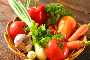 salad from fresh vegetables in a plate on a table, selective focus