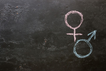 Male and female gender symbols on a black background