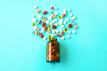 Medical pills and a bottle lie on the table. Medical concept