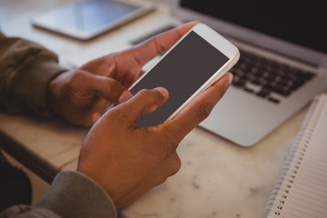 Cropped hands of man using phone