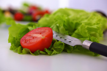 salad from fresh vegetables in a plate on a table, selective focus