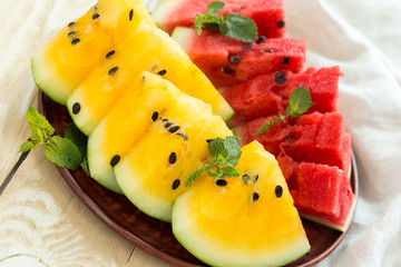 Yellow watermelon sliced on wooden background